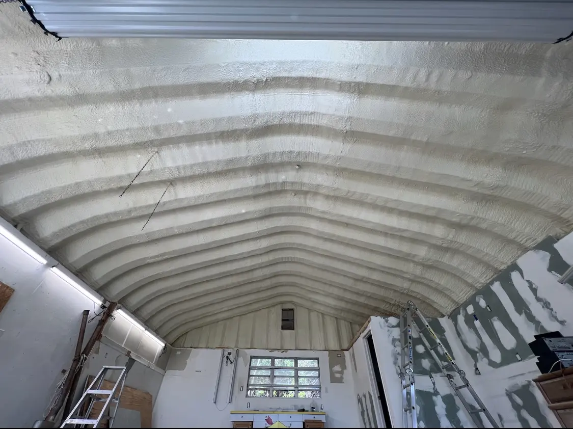 Spray polyurethane foam applied to the underside of a metal roof deck in Little Falls
